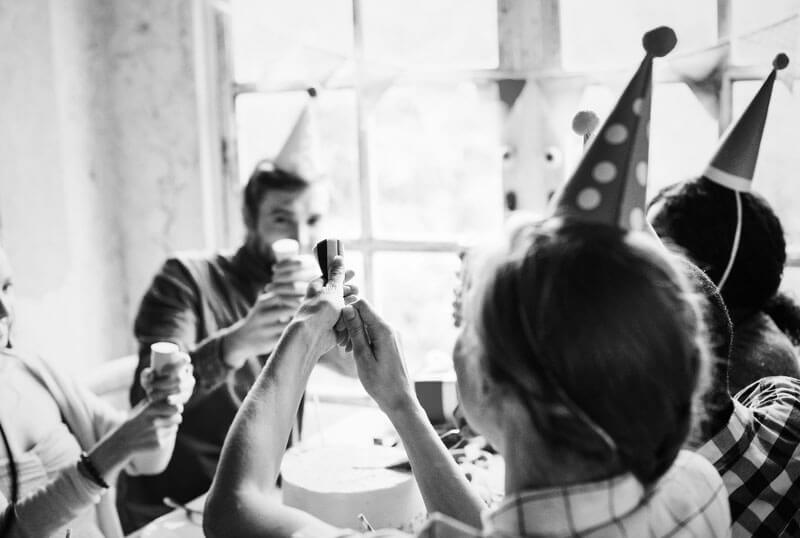 people wearing birthday hat enjoying party cape cod wedding planners