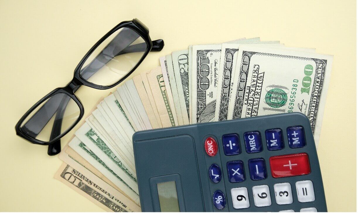 Image of glasses money and calculator cape cod