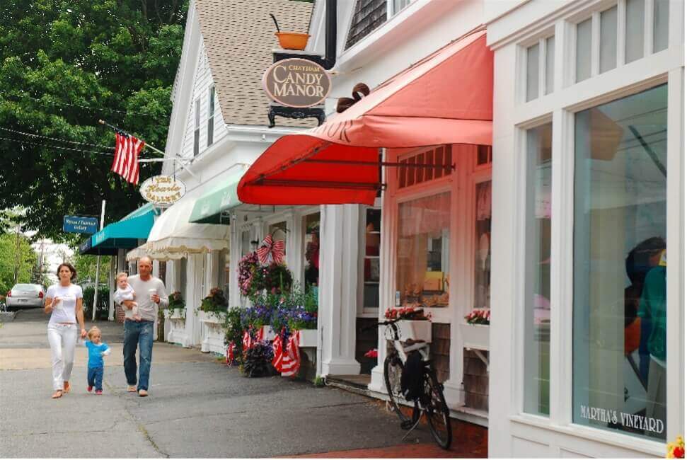tourist area couple walking on street in front of shops cape cod