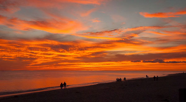 sunset silhouette people walking seashore cape cod