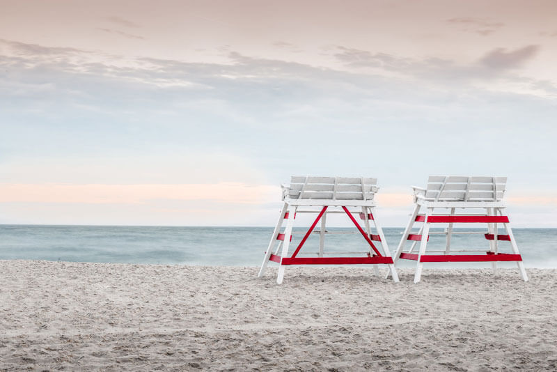 two white high bench facing ocean white sand cape cod island