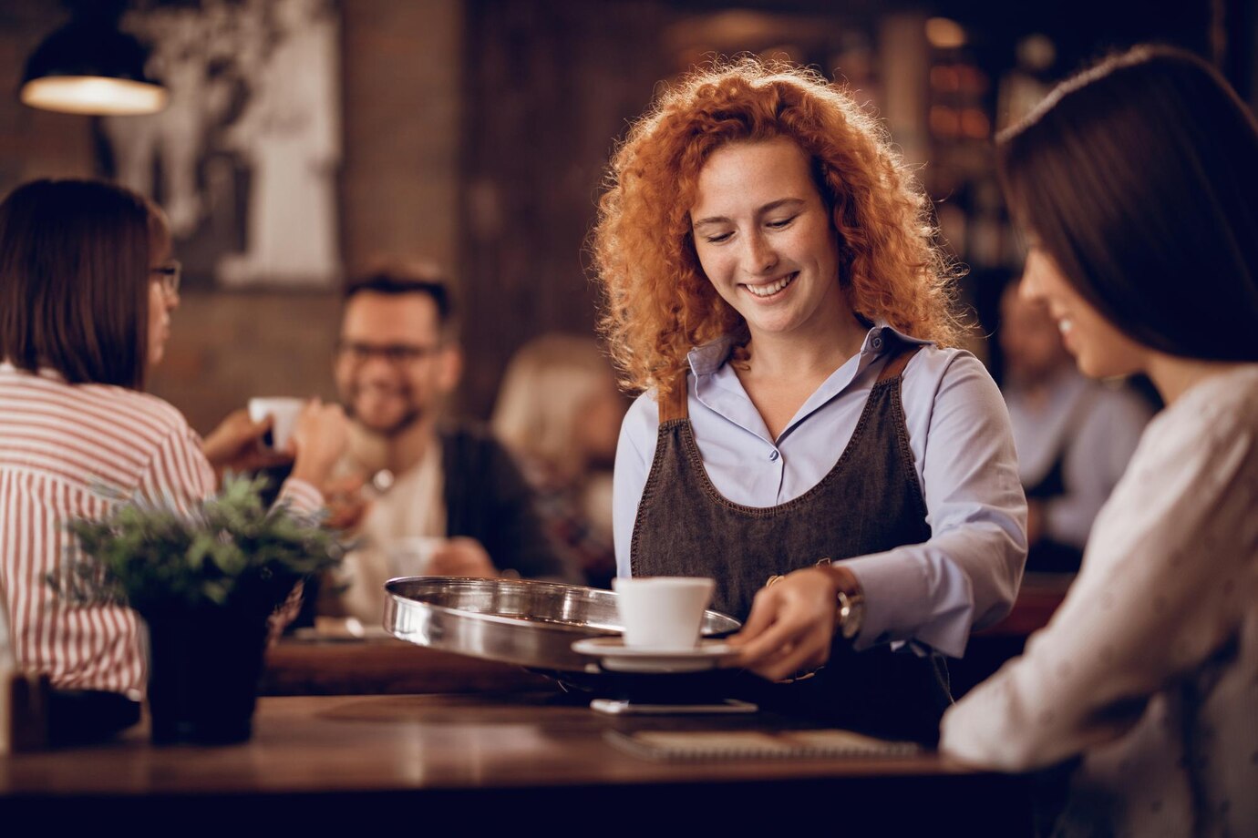 young happy waitress giving coffee female guest while working bar 637285 2441