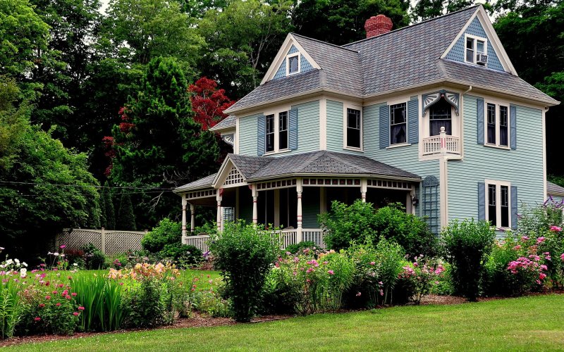 victorian era house in sandwich, massachusetts with summery flower garden